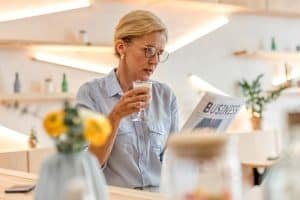 woman reading newspaper at home